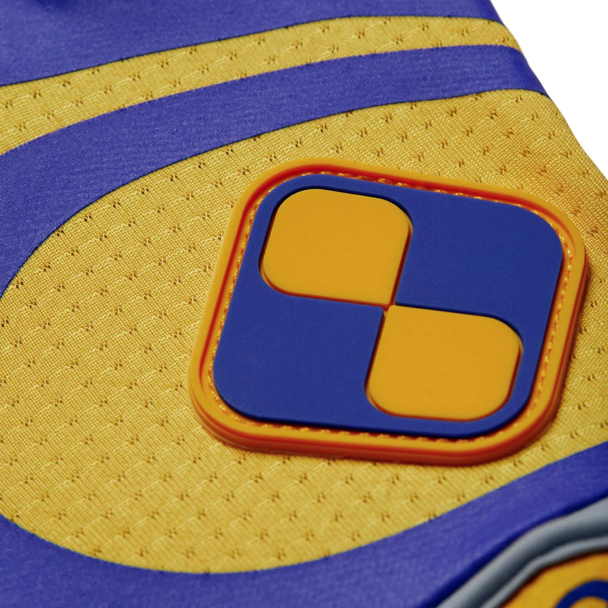 Close-up view of Ona EcoGrip Polo Gloves with a geometric pattern in yellow, blue, and white colors.