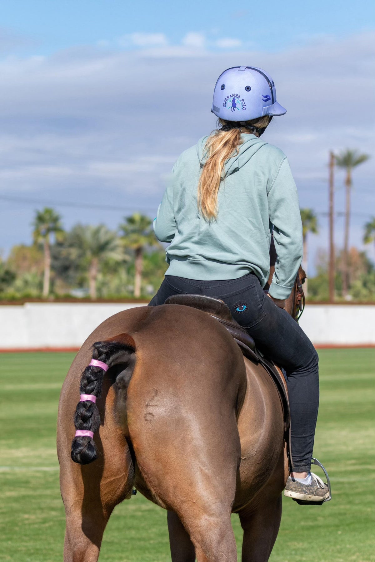 A woman riding in the Turmalina Polo Black Pants.